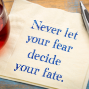 Never let fear decide your fate is written on a napkin