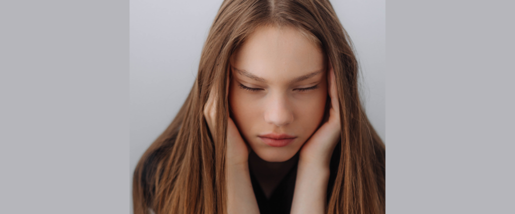 A girl covering her ears.