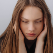 A girl covering her ears.